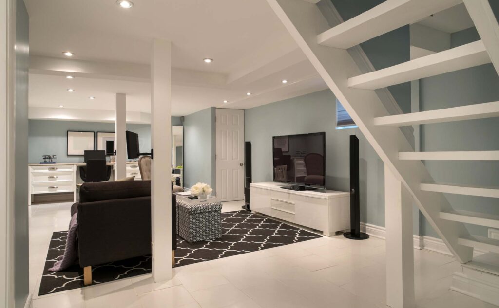 Utah basement finishing showing a modern finished basement with sitting area and television and stairs